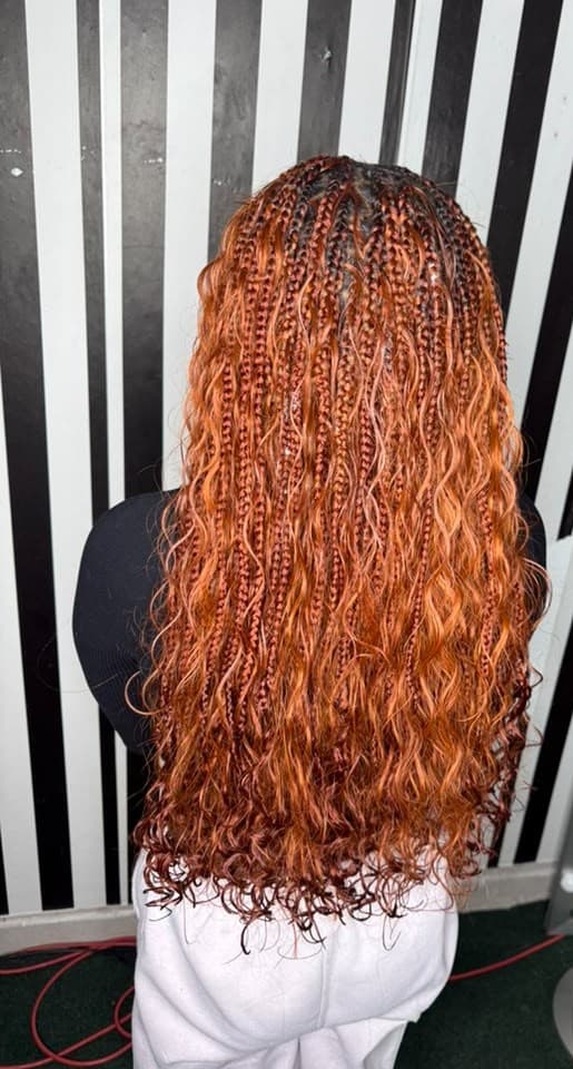Copper boho braids with loose curls, worn past the waist